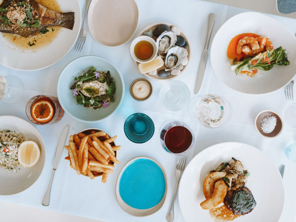 a spread of food and drinks at Rickys River Bar & Restaurant , Noosa Heads