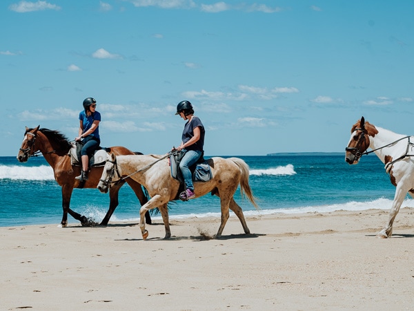 horse riding on the beach at Stand Tall Retreats.
