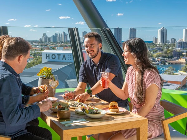 friends dining atop HOTA Gallery rooftop at The Exhibitionist Bar, Surfers Paradise