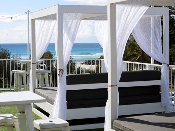 an open-air seating area with ocean views at The Pink Hotel, Coolangatta Beach 