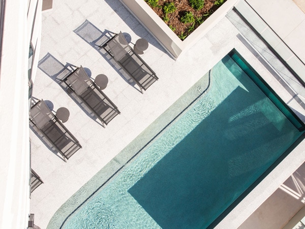 an overhead shot of the pool with sun loungers at Vue Broadbeach
