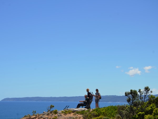 a person on a wheelchair overlooking the vast seascape