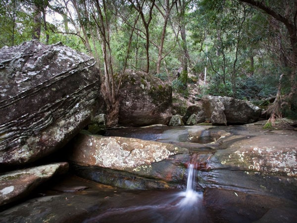 Water cascades over rocks in Berowra Creek off the Benowie Walking Track