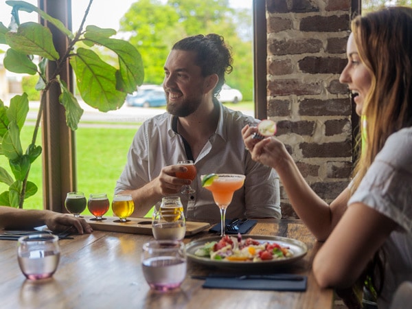 two people enjoying the food and drinks at Copperhead Brewery