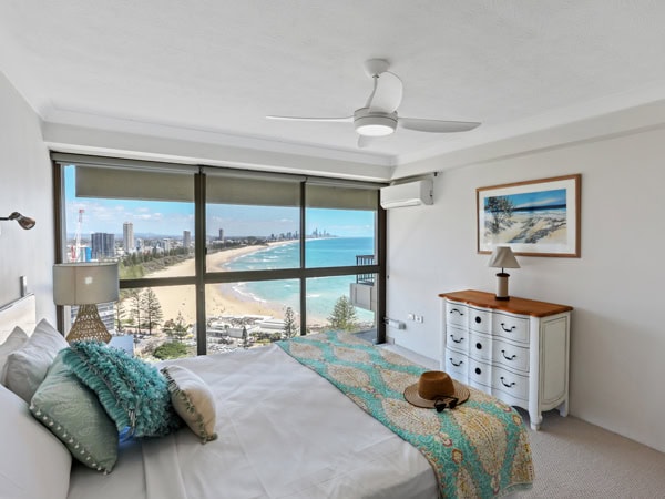 a bedroom with beach view at Gemini Court Holiday Apartments