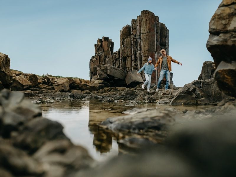 A couple explores Bombo Quarry on the Sapphire Coast, NSW