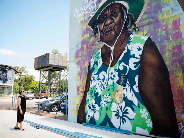 a woman looking at a Katherine Street Art