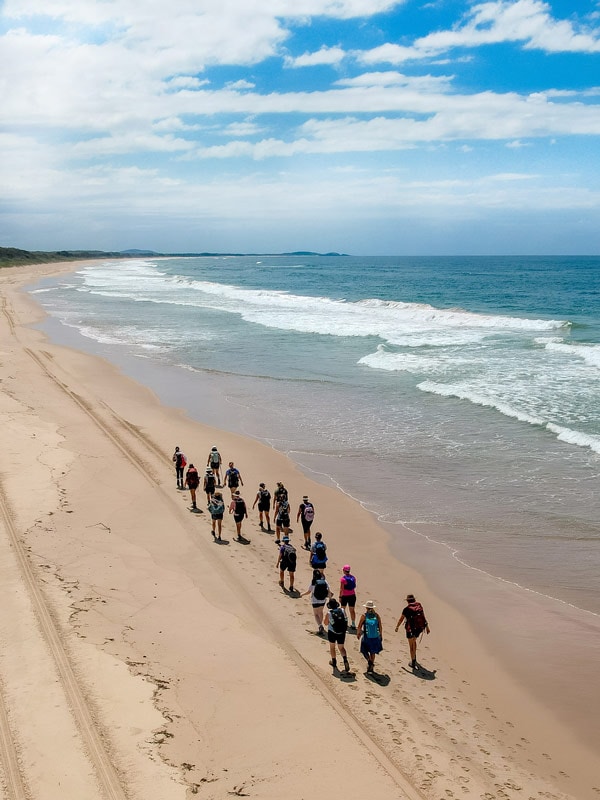 a group of people walking along the coastal path with Positive Energy Adventures and Retreats