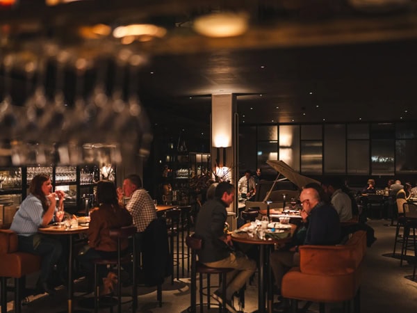 the dimly lit dining interior of Louis, Canberra