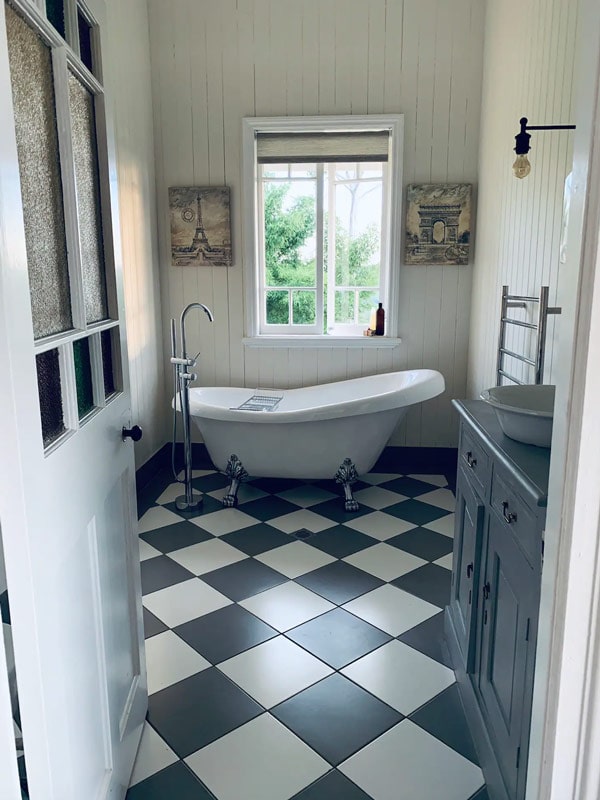 a bathtub inside a vintage bathroom at Mountaintop Queenslander Airbnb