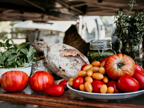 Tomatoes, sourdough and greens at Mullumbimby Farmers Market.