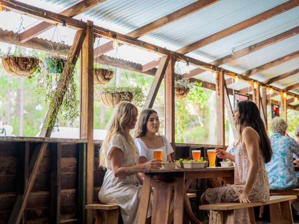 three women enjoying cold beer at Noosa Hinterland Brewery Interior