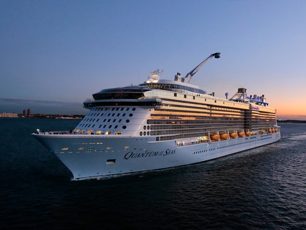 The Royal Caribbean Quantum of the Seas navigating the sea at dusk