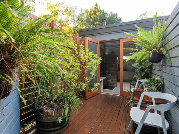 plants surrounding the entrance of The Rustic Greenhouse