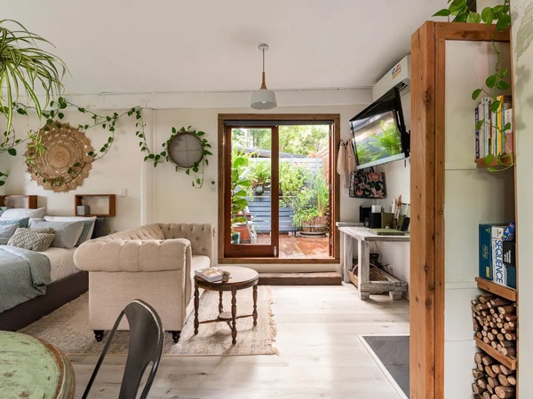 a look inside the interior filled with plants at The Rustic Greenhouse