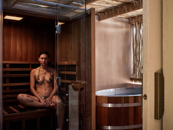 A woman makes use of The Swell's sauna and steam room.