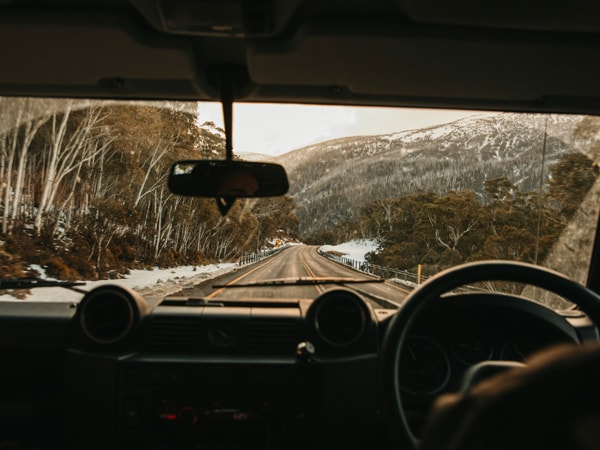 Driving in Thredbo with the snow covered mountains around.