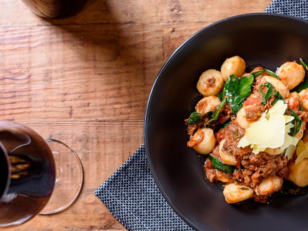 a tabletop view of food and a glass of wine at Uneke Lounge, Wagga Wagga