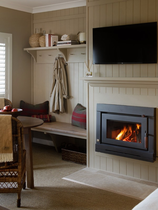 a cosy fireplace inside Verandah House Country Estate