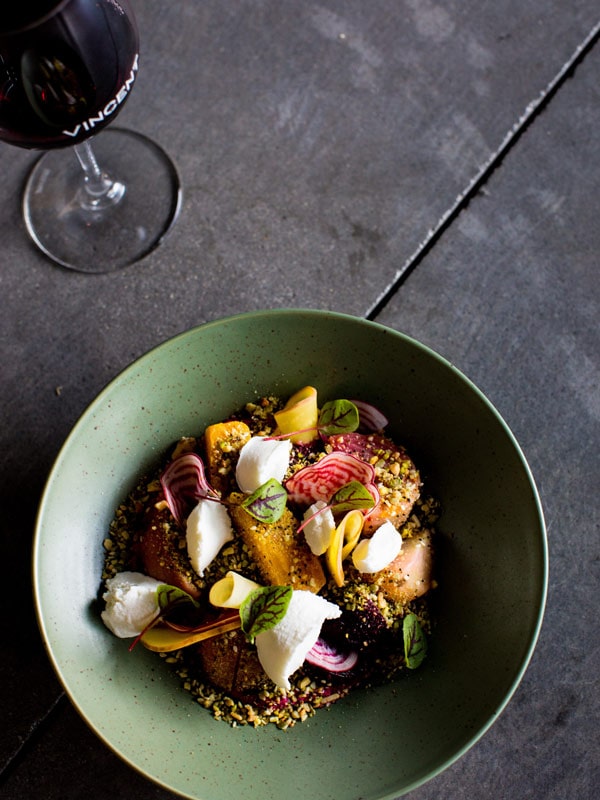 a bowl of food with a glass of wine at Vincent, Canberra