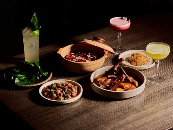 a spread of food and cocktails on the table at Wilma, Canberra