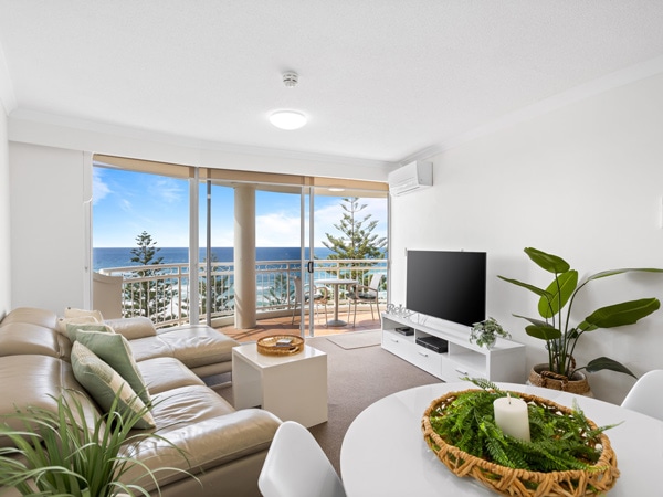 a living room with a balcony and ocean views at Burleigh Mediterranean