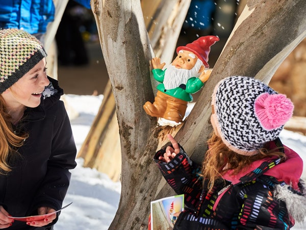 two little girls playing with a gnome