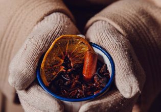 a hand holding a mug of mulled wine from The Haus Hahndorf