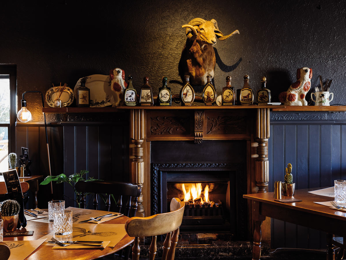 Tables by the fireplace at Clarendon Arms