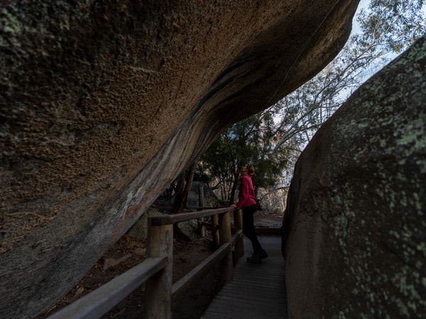 a woman admiring the Yankee Hat Rock Painting in Namadgi National Park, Canberra, ACT