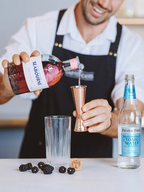 Bartender making gin and tonic at Seabourne Distillery in Noosa