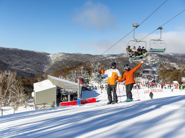 two people skiing below the Merritts Gondola in Thredbo Ski Resort