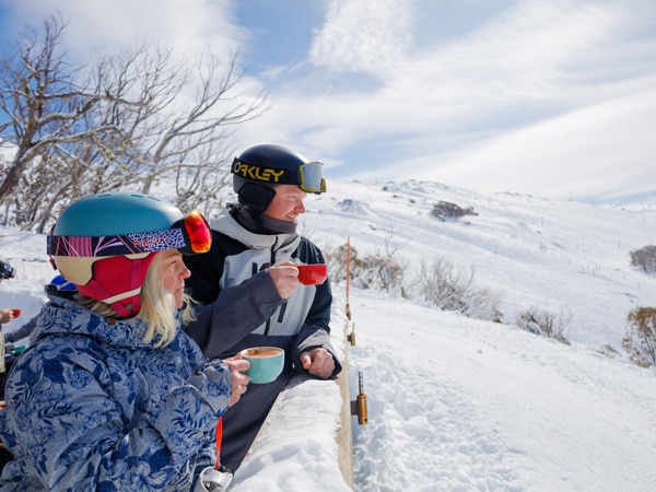 a couple sipping coffee at Thredbo Ski Resort