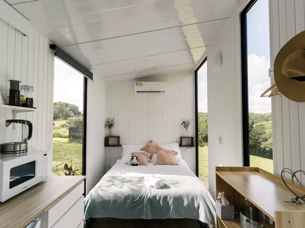 a bedroom with nature views at Rainforest Sunsets, Airbnb Cairns