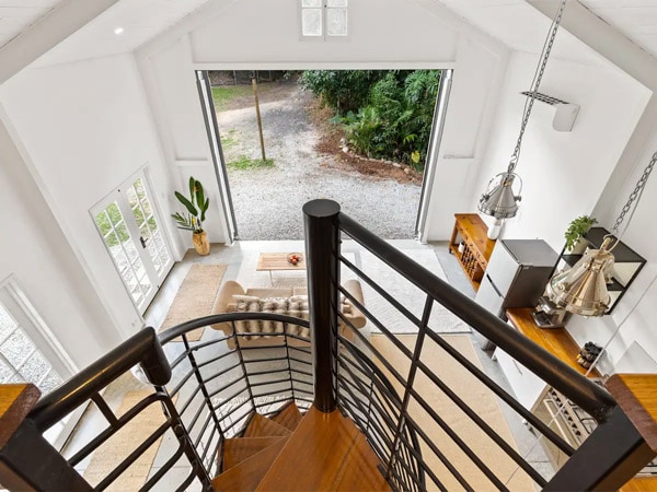 a spiral staircase inside a barn loft Airbnb in Redlynch Valley, Cairns