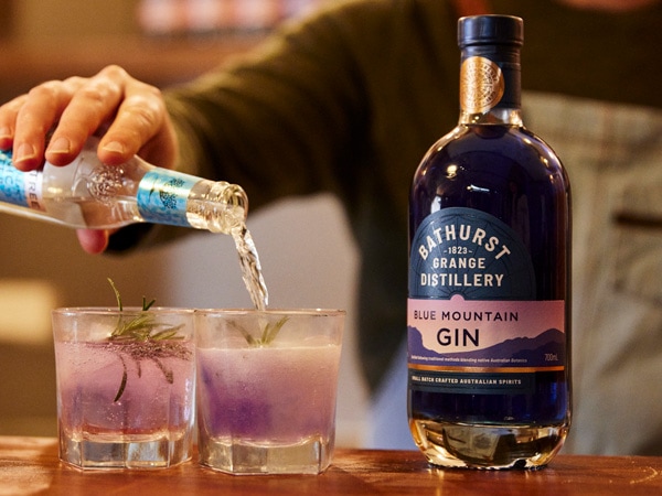 a person pouring gin into the glass at Bathurst Grange Distillery