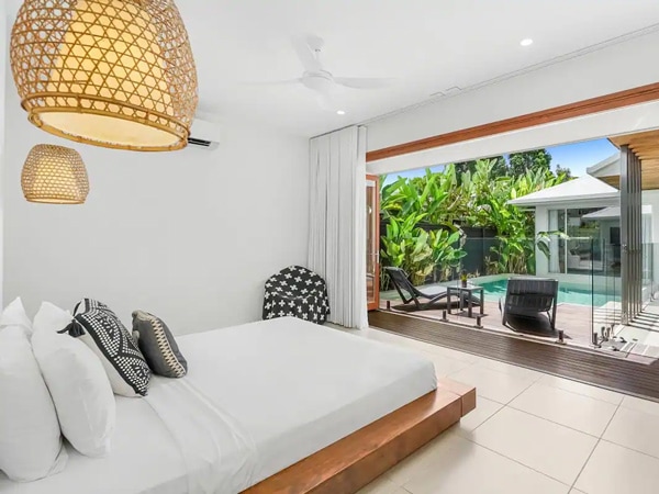 a bedroom alongside a private pool in Belle Escapes Cairns