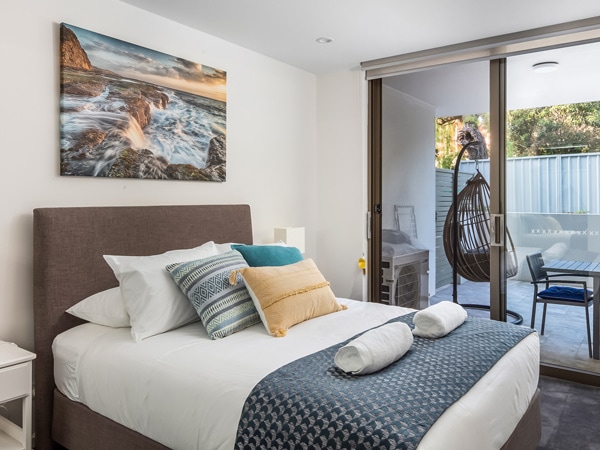 the bedroom with an outdoor deck at Bluewater Apartments, Kiama