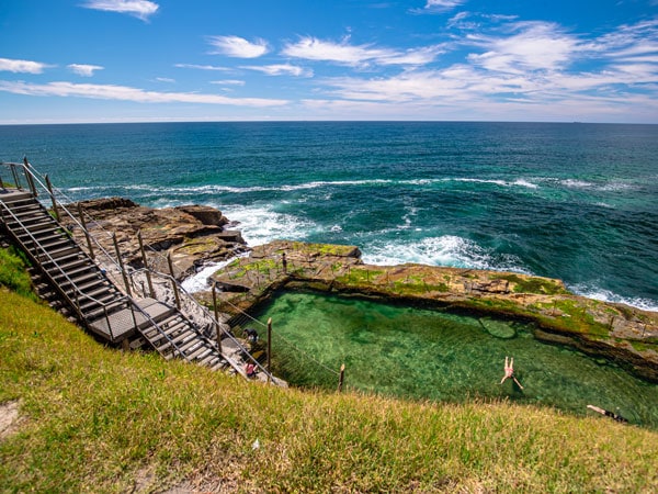 an aerial view of a woman swimming in Bogey Hole, Newcastle