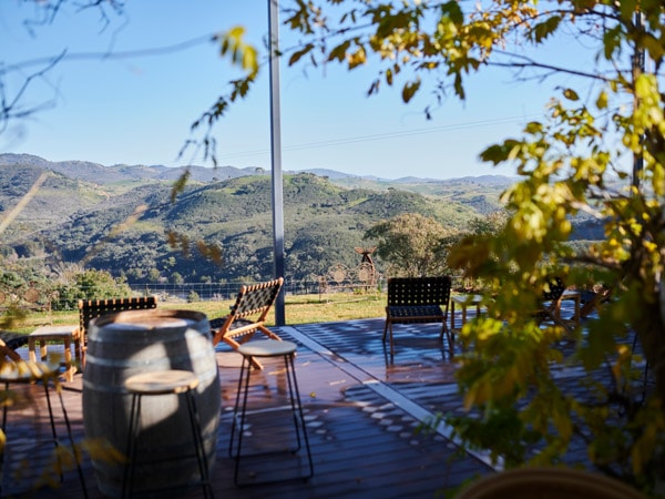 an outdoor deck overlooking scenic mountain views at Brindbella Hills Winery, Canberra