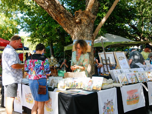 a couple buying gifts at November Christmas Market, Broome