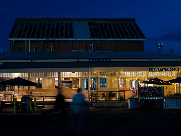 the exterior of Reckless Brewing with fairy lights