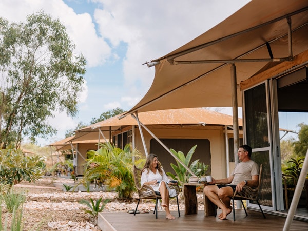 a couple sitting outside their luxury safari tent at Cygnet Bay Pearl Farm