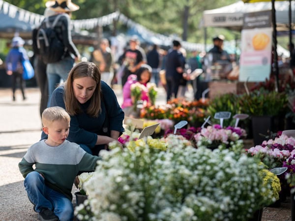 a mother and son at a plant stall in Haig Park Village Markets, Canberra