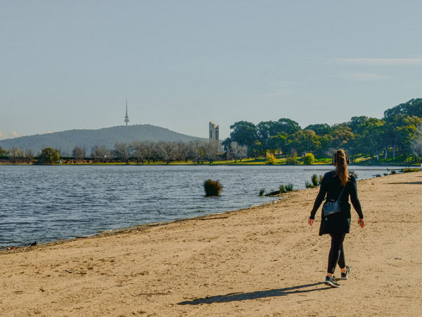 a woman walking along Grevillea Park