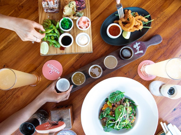 a table-top view of food and drinks at Matso's Brewery, Broome