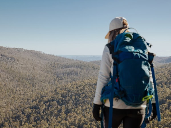 a female hiker standing on top of Namadgi National Park