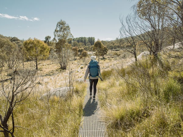 a woman walking at Namadgi National Park