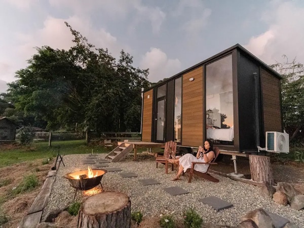a woman relaxing in front of a bonfire at Rainforest Sunsets, Kuranda, Cairns