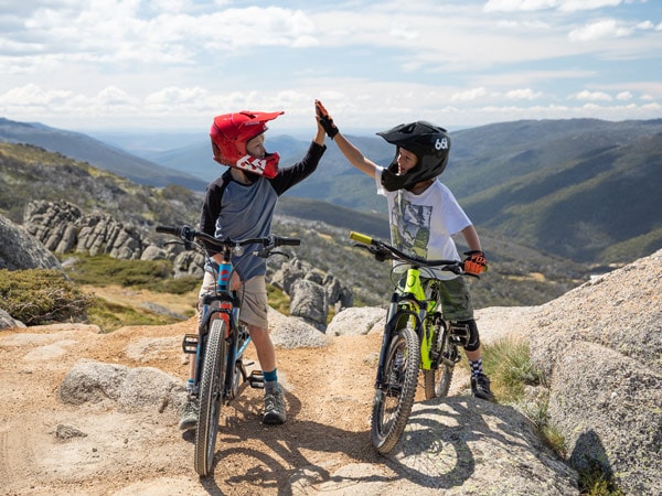 two kids at Thredbo MTB doing a high-five